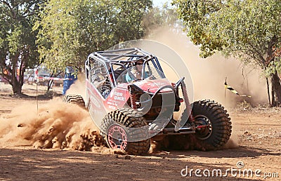 Red car kicking up dust during speed timed trial event Editorial Stock Photo
